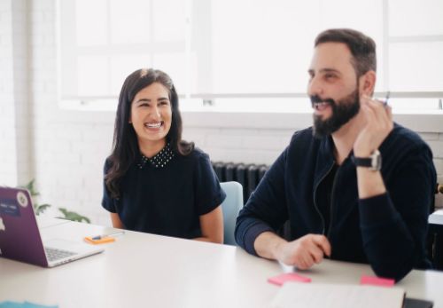 Two people working on computer | custom sign consultation