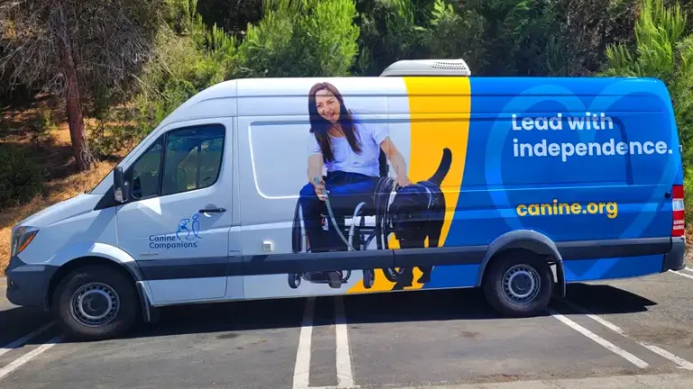 Canine Companions van wrap by Innovative Sign Systems featuring service dog and wheelchair user, parked in Oceanside, CA